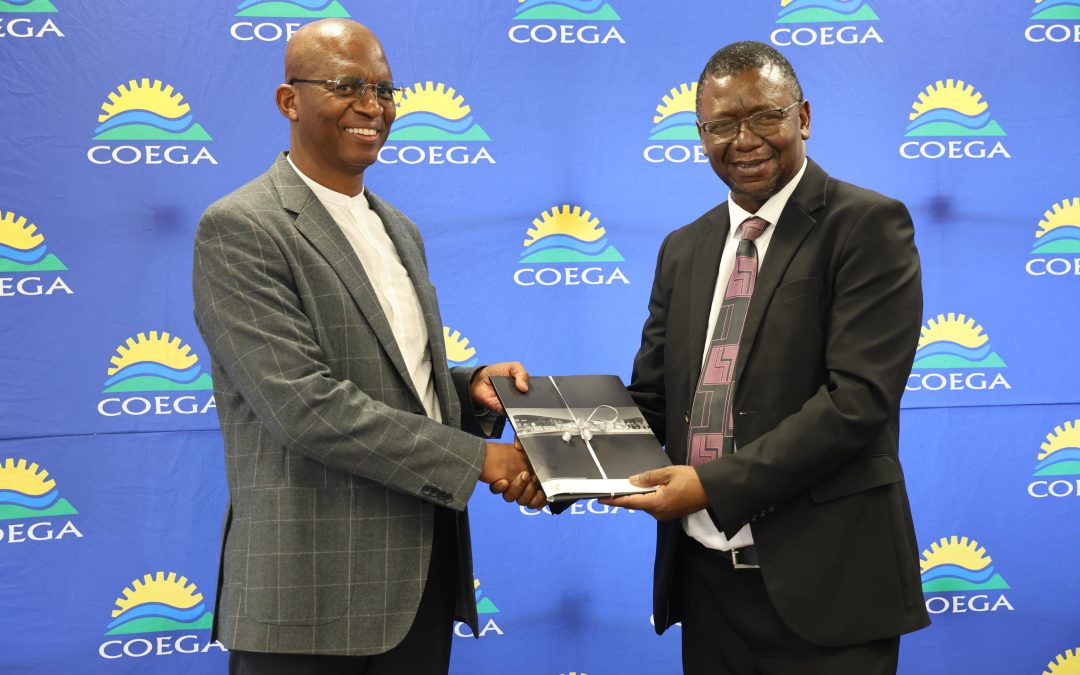 Dr. Mpumi Mabula, Coega Executive Manager: Infrastructure Planning and Development, receiving the latest Coega SEZ Census Report from Mr. Harry Thema, Stats SA Chief Director: Economic Sub System.